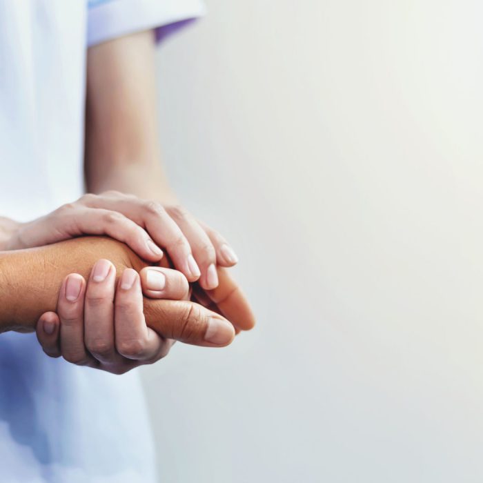 A nurse shaking hands to encourage the patient
